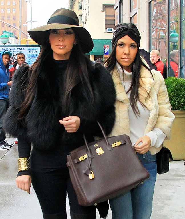 Kourtney Kardashian, cream faux fur jacket, head wrap, jeans, white turtleneck sweater, Kim Kardashian, black fur coat, gold bracelet, black pants, brown hat, brown bag